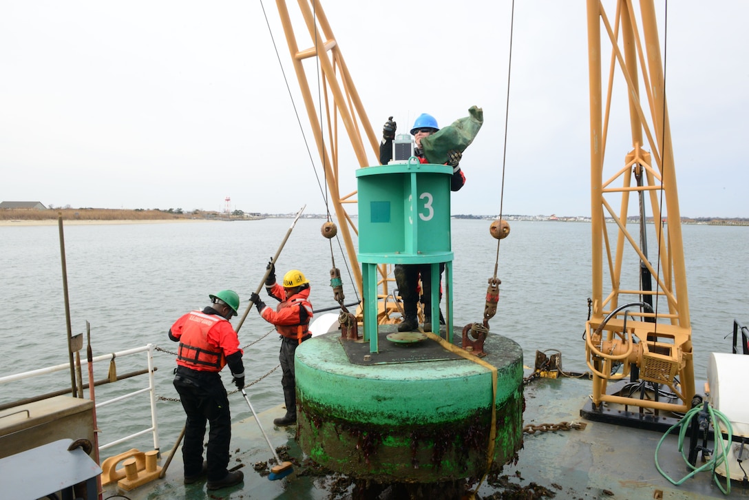 Image of Coast Guard crew working aids to navigation buoys.