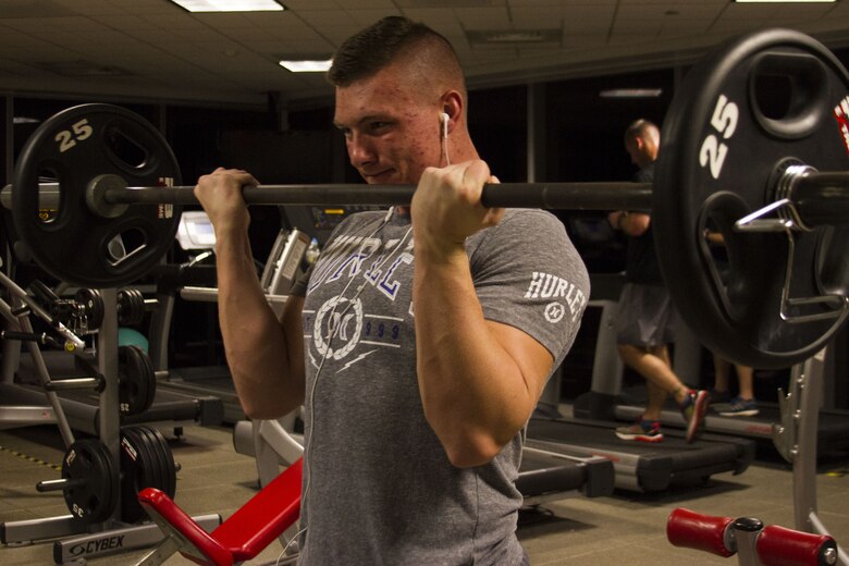 Marine Pfc. Austin D. Gill, a native of Tyronza, Arkansas, and graduate of East Poinsett County High School, performs 95-pound bicep curls at the John Wesley Marsh Center gym, aboard Marine Corps Base Quantico, Virginia, Nov. 29, 2017. Gill applies his self-motivation to work every day in the United States Marine Corps, constantly looking to better himself and build his strength. Gill is an administrative specialist and waivers clerk for the Marine Corps Recruiting Command. "I just like to sweat and challenge myself to push for greatness," Gill said. (Marine Corps photo by Pfc. Naomi Marcom)