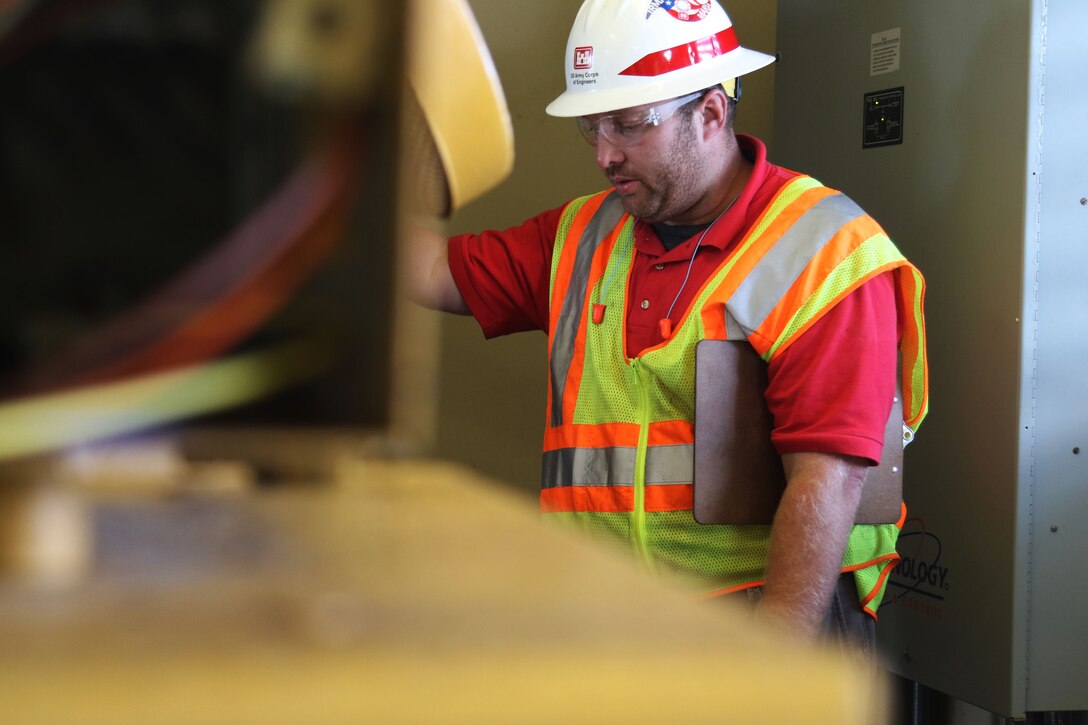 man inspects generator