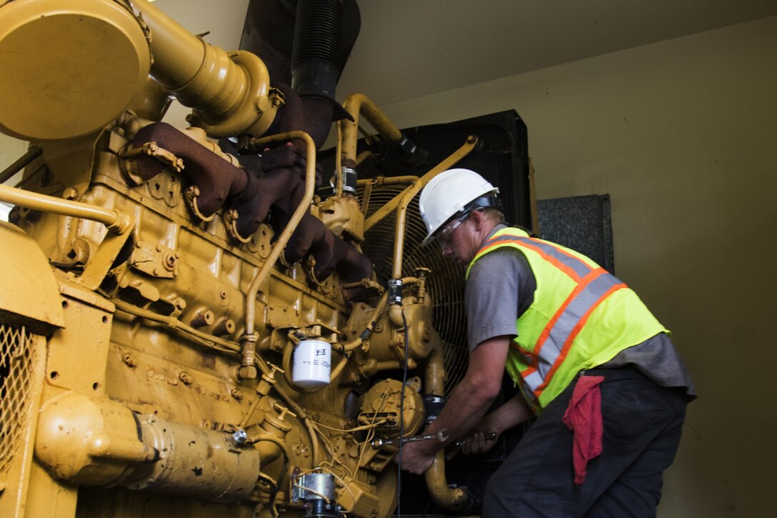 man fixes old generator