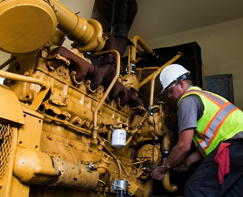 Cody Mercer, a government contractor mechanic, works on repairing a generator that powers a flood control pump near San Juan, Puerto Rico Dec. 27. The repairs are part of the U.S. Army Corps of Engineers' Non-Federal Generator Operation and Maintenance mission in support of FEMA's Hurricane Maria recovery efforts.