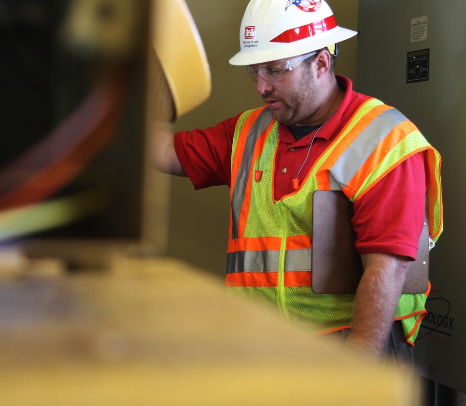 Mike Bauman, from the U.S. Army Corps of Engineers Honolulu District, inspects a generator for a flood control pump near San Juan, Puerto Rico Dec. 27. Bauman has been working in Puerto Rico as a Quality Assurance technician for the Non-Federal Generator Operation and Maintenance mission since late October. He says the mission is challenging, but that it's "always rewarding to help and give back to these communities."