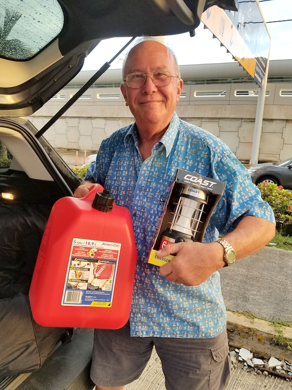 Alberto Marquez, father of Huntsville Center employee Maria Brito, holds up a couple of the items passed along to him by Neriah Holly, an architect with Huntsville Center, Nov. 11, 2017, during Holly’s monthlong deployment in support of Operation Blue Roof. Brito serves as a secretary in Resource Management and coordinated with Holly to hand off the supplies to Marquez during Holly’s time on the island.