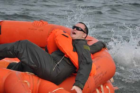 A member of the 94th Operations Group grabs onto a life raft during combat and water survival training at Naval Air Station Key West, Florida Feb. 23, 2017. According to Col. Patrick Campbell, 94th Operations Group commander, this marks the first time this training has completed by aircrew, aeromedical and aircrew flight equipment personnel at the same time.