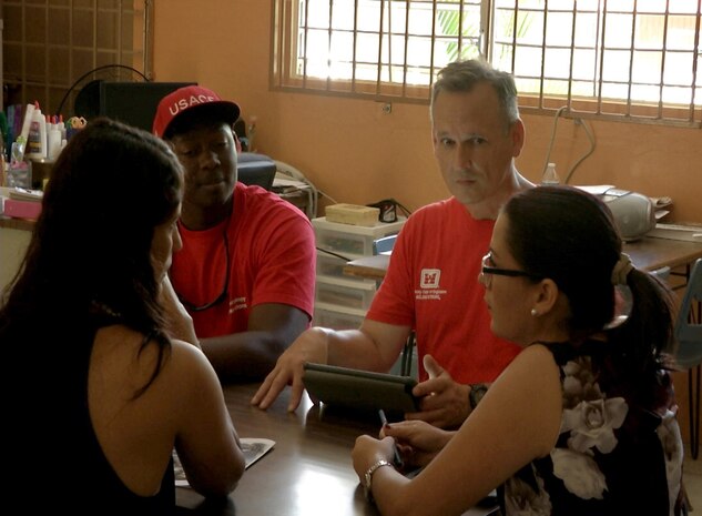 men discuss school assessment with faculty
