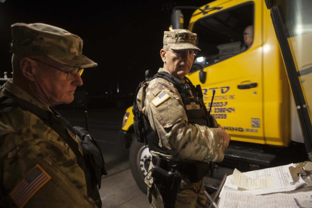 California State Military Reserve Staff Sgt. James Fitzgerald, left, and California State Military Reserve Spc. Juan Ossa, right, both with the Installation Support Command, finish logging delivering supplies.