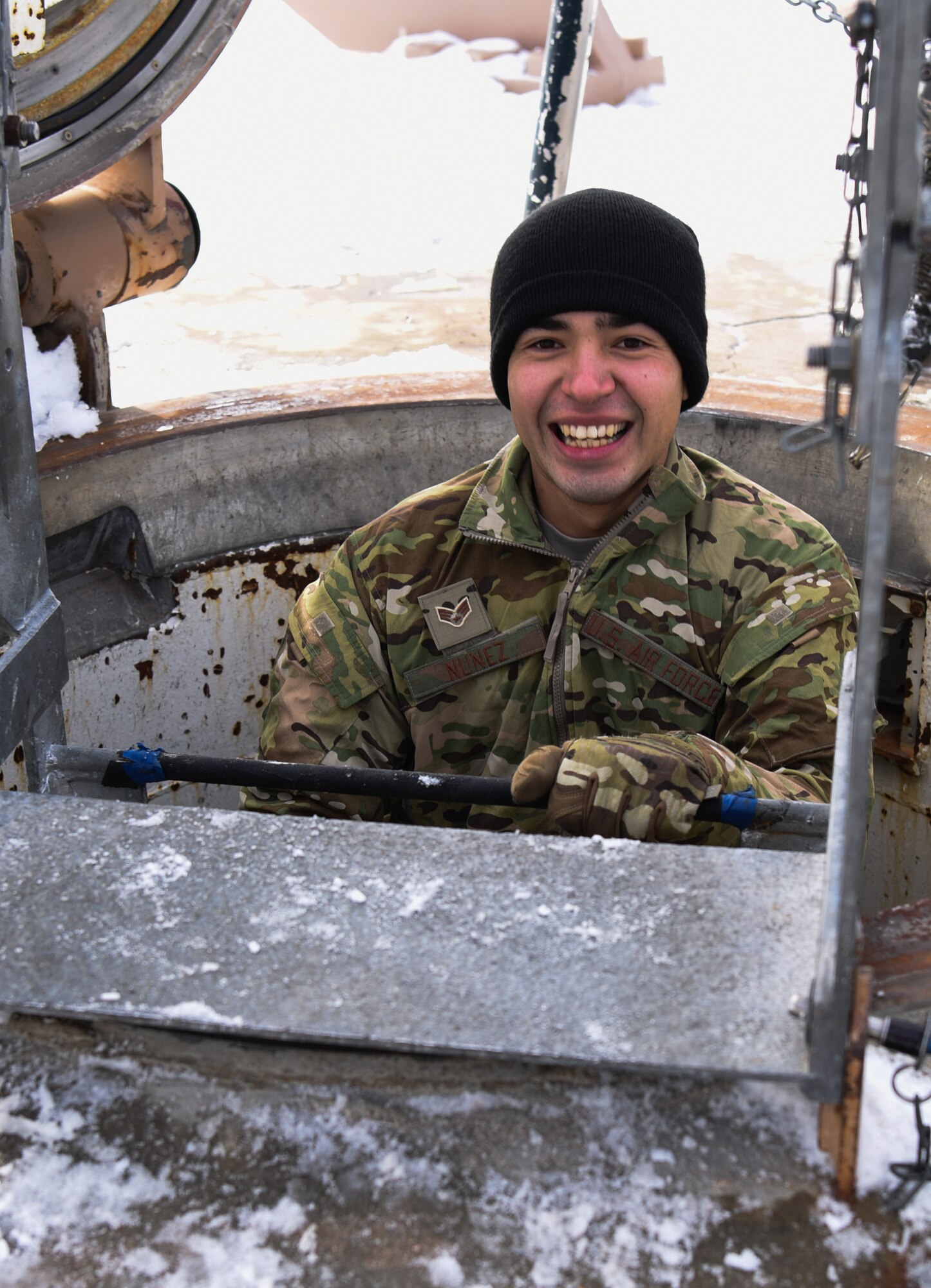 Senior Airman Dereck Nunez, 90th Missile Security Forces flight security controller, smiles for the camera while descending a ladder in the F.E. Warren Air Force Base missile complex, Dec. 28, 2017. Members of the 90th Missile Security Forces Squadron got the chance to go into a missile launch facility to see what they protect every day.