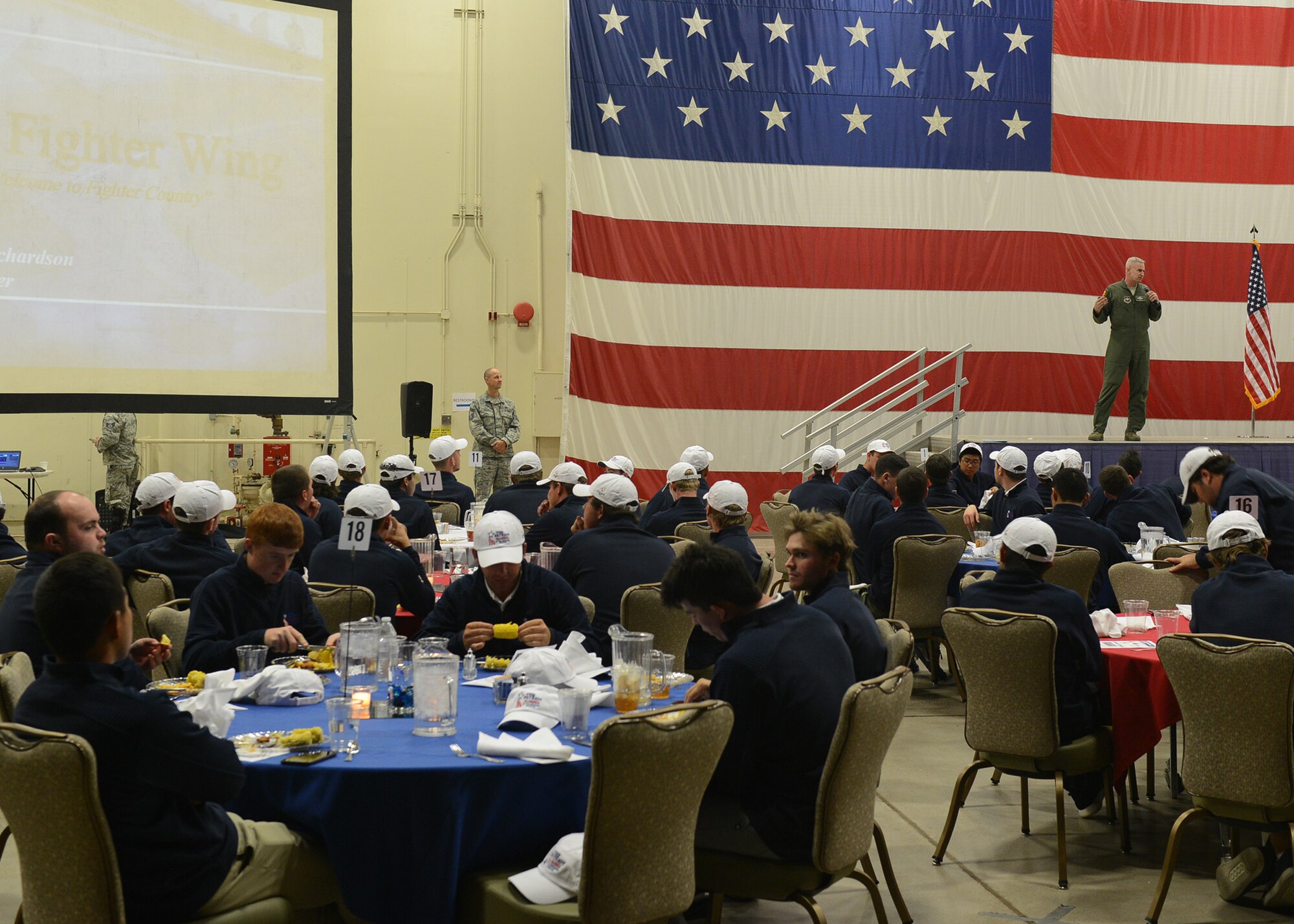 Col. Michael Richardson, 56th Fighter Wing vice commander, talks about the importance of the mission at the end of the All American Golf Tournament tour at Luke Air Force Base, Ariz., Dec. 27, 2017. The tournament players were able to see units around the base supporting the mission to build the future of airpower. (U.S. Air Force photo by Senior Airman James Hensley)