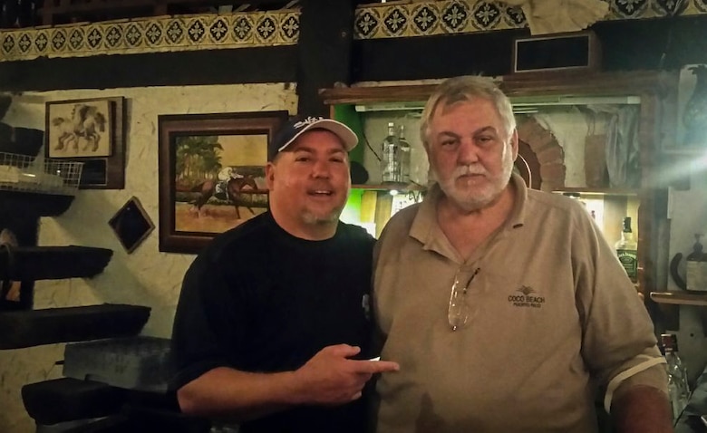 two men pose at Christmas party