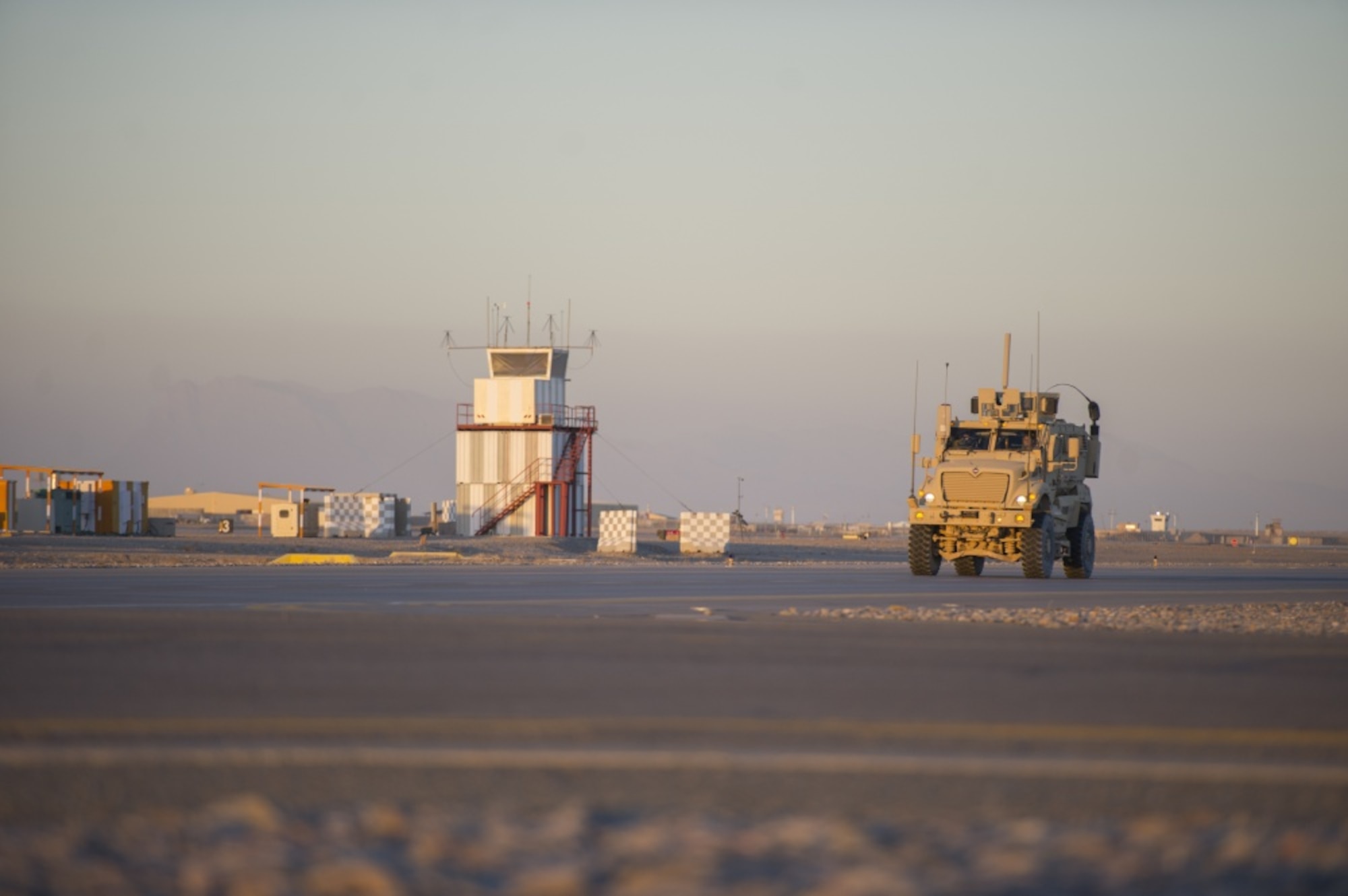A Mine Resistant Ambush Protected vehicle, driven by a member of the 451st Expeditionary Support Squadron Security Forces Flight, patrols the flight line at Kandahar Airfield, Afghanistan, Jan. 20, 2016. The U.S. Air Forces Central Command Force Protection directorate at the Combined Air Operations Center at Al Udeid Air Base, Qatar, acts as the nexus of security operations across the area of responsibility to ensure security forces personnel can protect personnel, assets and, ultimately, the mission. (U.S. Air Force photo/Tech. Sgt. Robert Cloys) 