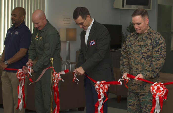Honored guests cut the ribbon during the United Service Organization Iwakuni grand opening at Marine Corps Air Station Iwakuni, Japan, Jan. 31, 2017. A ribbon-cutting ceremony was held to signify the official opening. Sponsors and guests toured the facility after the ceremony while enjoying complimentary snacks and refreshments. (U.S. Marine Corps photo by Lance Cpl. Gabriela Garcia-Herrera)
