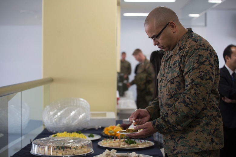 U.S. Marine Corps Master Gunnery Sgt. John Wade, provost sergeant for Marine Corps Air Station Iwakuni, enjoys complimentary snacks and refreshments during the United Service Organization Iwakuni grand opening at MCAS Iwakuni, Japan, Jan. 31, 2017. A ribbon-cutting ceremony was held to signify the official opening. The USO is a non-profit organization that provides military personnel with services to help them stay in touch with their loved ones back home. (U.S. Marine Corps photo by Lance Cpl. Gabriela Garcia-Herrera)