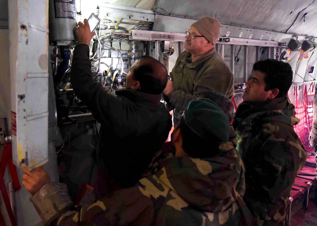 Master Sgt. Steven Ashley, 440th Air Expeditionary Advisory Squadron, C-130 maintenance advisor, assigned to Dobbins Air Reserve Base, Ga., trains Afghan Air Force maintainers on interior systems in a C-130H at Kabul Air Wing, Afghanistan, Jan. 18, 2017. On Jan. 11, 2017, a group of 44 AAF C-130H maintainers were the first in-country trained to graduate and receive their level three certification.  
The recent graduates were trained by Total Force Airmen who specialize in various maintenance Air Force Specialty Codes from; engine and propulsion, hydraulics, fuel, electrical and environmental, avionics, and crew chief specialist. (U.S. Air Force photo by Tech. Sgt. Veronica Pierce)
