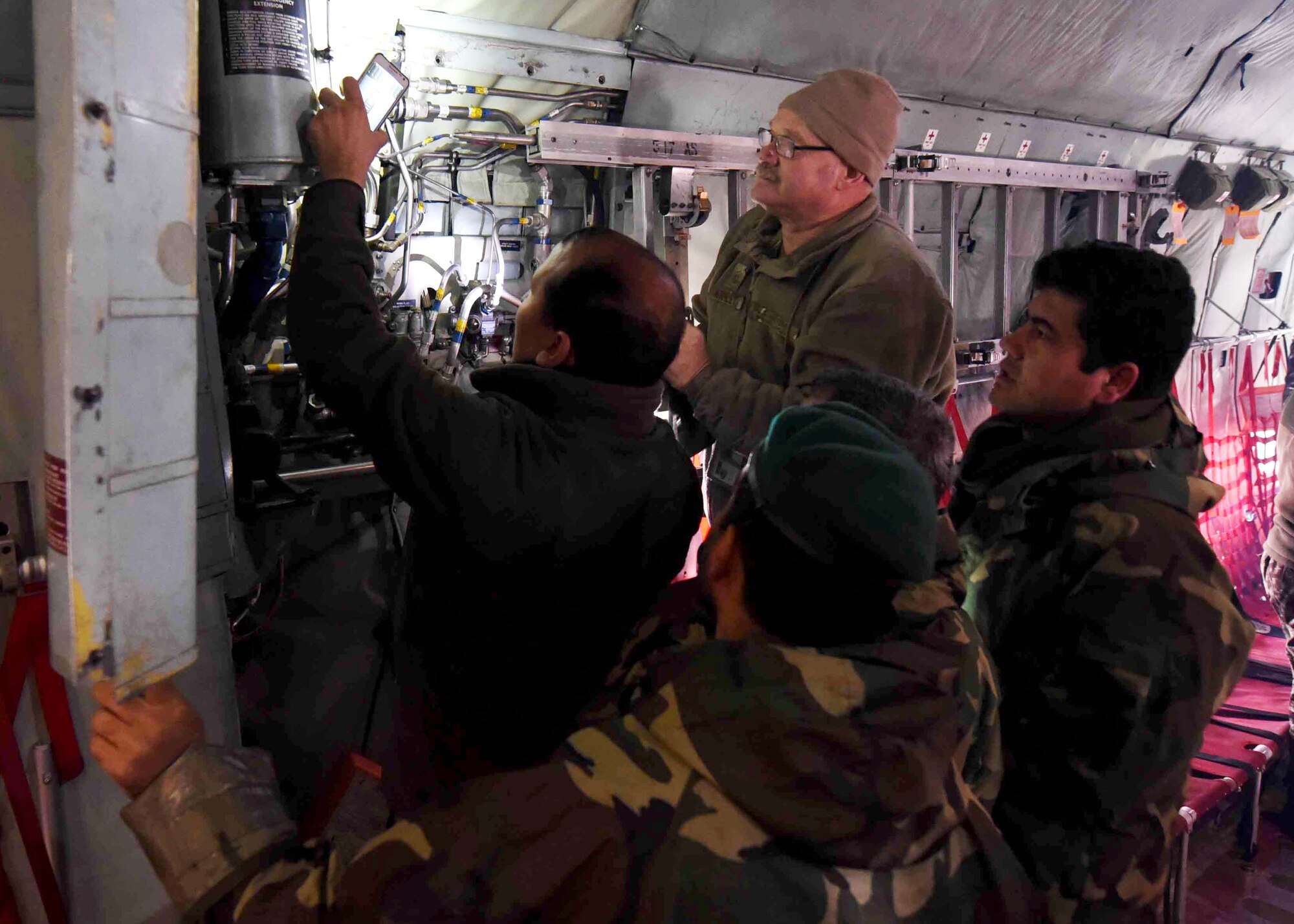 Master Sgt. Steven Ashley, 440th Air Expeditionary Advisory Squadron, C-130 maintenance advisor, assigned to Dobbins Air Reserve Base, Ga., trains Afghan Air Force maintainers on interior systems in a C-130H at Kabul Air Wing, Afghanistan, Jan. 18, 2017. On Jan. 11, 2017, a group of 44 AAF C-130H maintainers were the first in-country trained to graduate and receive their level three certification.  
The recent graduates were trained by Total Force Airmen who specialize in various maintenance Air Force Specialty Codes from; engine and propulsion, hydraulics, fuel, electrical and environmental, avionics, and crew chief specialist. (U.S. Air Force photo by Tech. Sgt. Veronica Pierce)
