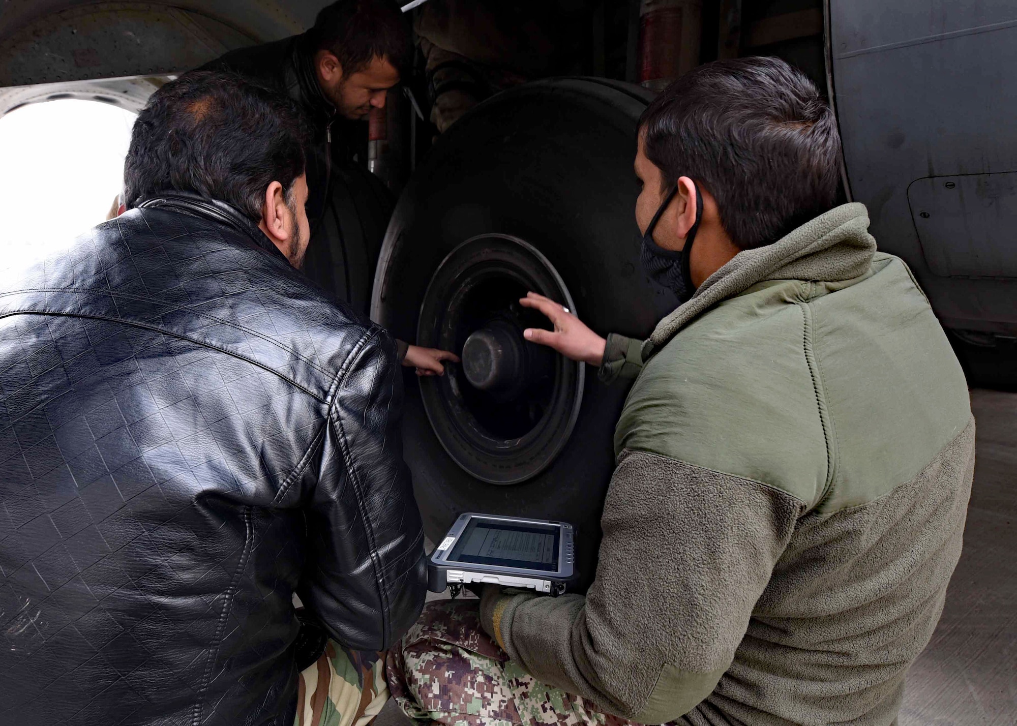 An Afghan Air Force C-130 maintenance chief master sergeant trains AAF noncommissioned officers on C-130 maintenance using technical orders at Kabul Air Wing, Afghanistan, Jan. 18, 2017. Maintenance advisors from Train, Advise, Assist Command-Air (TAAC-Air), worked with their AAF counterparts for the past six months to qualify a group of AAF members as level three maintainers. On Jan. 11, 2017, 44 AAF C-130H maintainers were the first in-country trained to graduate and receive their level three certification. (U.S. Air Force photo by Tech. Sgt. Veronica Pierce)
