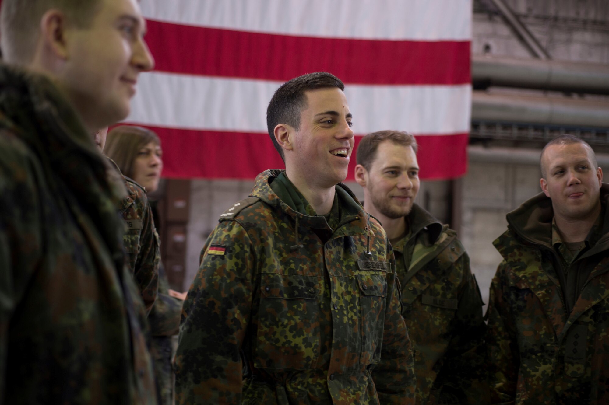 German air force members are briefed about the engine structure of an F-16 Fighting Falcon during a tour of Hangar 1 at Spangdahlem Air Base, Germany, Jan. 31, 2017. The German af visited as part of their Advanced Air Mission Control Course, and the group will also visit Buechel AB and Polygone Control Center, Bann, Germany, on the tour. (U.S. Air Force photo by Senior Airman Dawn M. Weber)