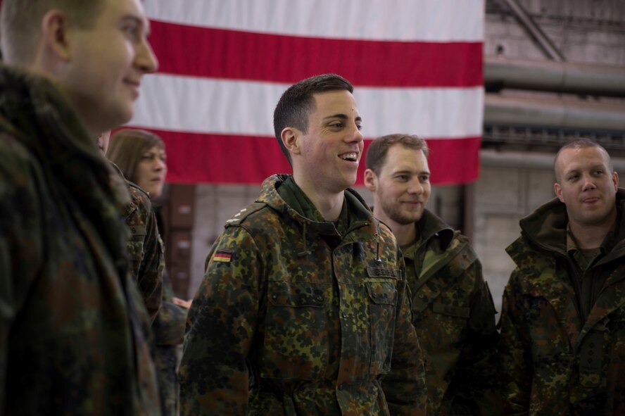 German air force members are briefed about the engine structure of an F-16 Fighting Falcon during a tour of Hangar 1 at Spangdahlem Air Base, Germany, Jan. 31, 2017. The German af visited as part of their Advanced Air Mission Control Course, and the group will also visit Buechel AB and Polygone Control Center, Bann, Germany, on the tour. (U.S. Air Force photo by Senior Airman Dawn M. Weber)