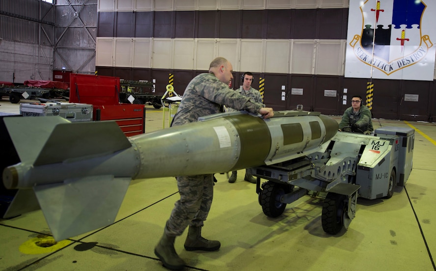 U.S. Air Force Airman 1st Class Brandon Shoulta, 52nd Aircraft Maintenance Squadron aircraft armament specialist, positions an MJ-IC jammer in Hangar 1 during a tour for members of the German air force at Spangdahlem Air Base, Germany, Jan. 31, 2017. The German af was given a tour of visiting various facilities such as the fitness center, the tower and Hangar 1 as a way to bolster U.S. and German partnerships. (U.S. Air Force photo by Senior Airman Dawn M. Weber)