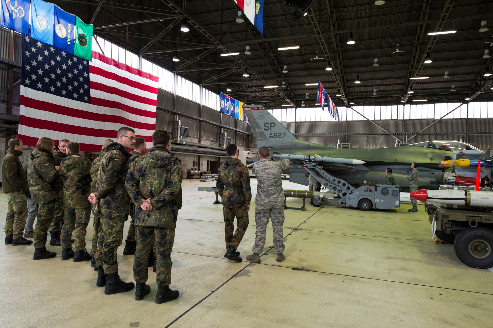 German air force members view an F-16 Fighting Falcon in Hangar 1 during a tour of Spangdahlem Air Base, Germany, Jan. 31, 2017. The German af visited Spangdahlem AB as part of their Advanced Air Mission Control Course and, the group will also visit Buechel AB and Polygone Control Center, Bann, Germany, on the tour. (U.S. Air Force photo by Senior Airman Dawn M. Weber)