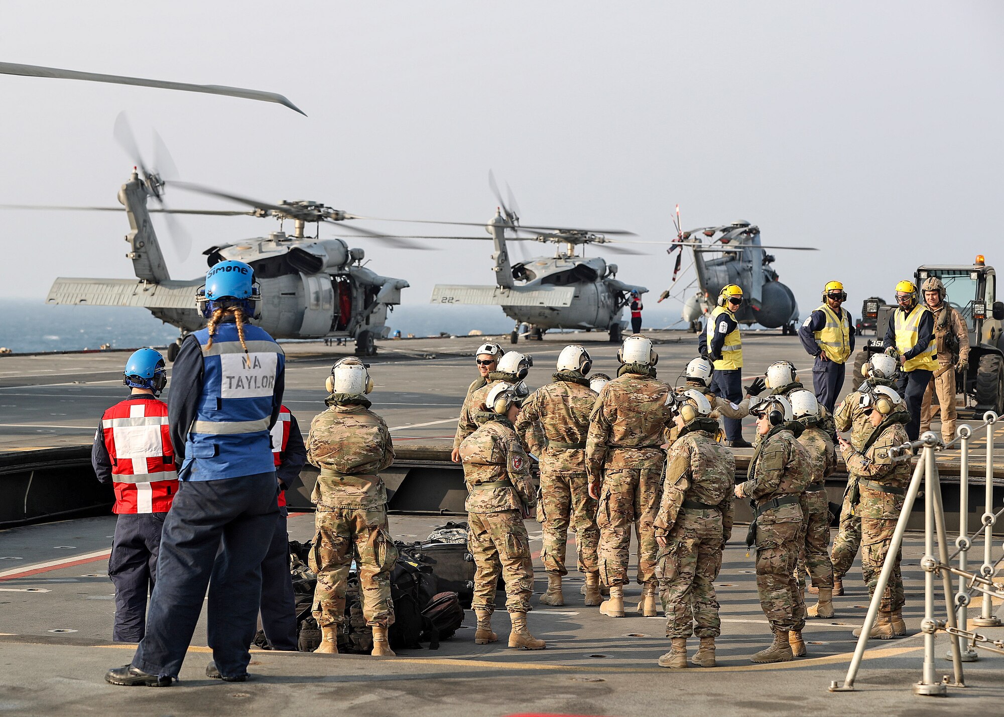 The 379th Expeditionary Medical Operations Squadron mobile field surgical and critical care teams embark on the HMS Ocean via a U.S. Navy SH-60 Sea Hawk helicpoter, Jan. 23, 2017. The MFST-ECCT medical personnel participated in exercise Azraq Serpent, where they joined coalition forces to simulate setting up a role two surgical and critical care facility on a maritime platform. (Courtesy photo, Royal Navy)