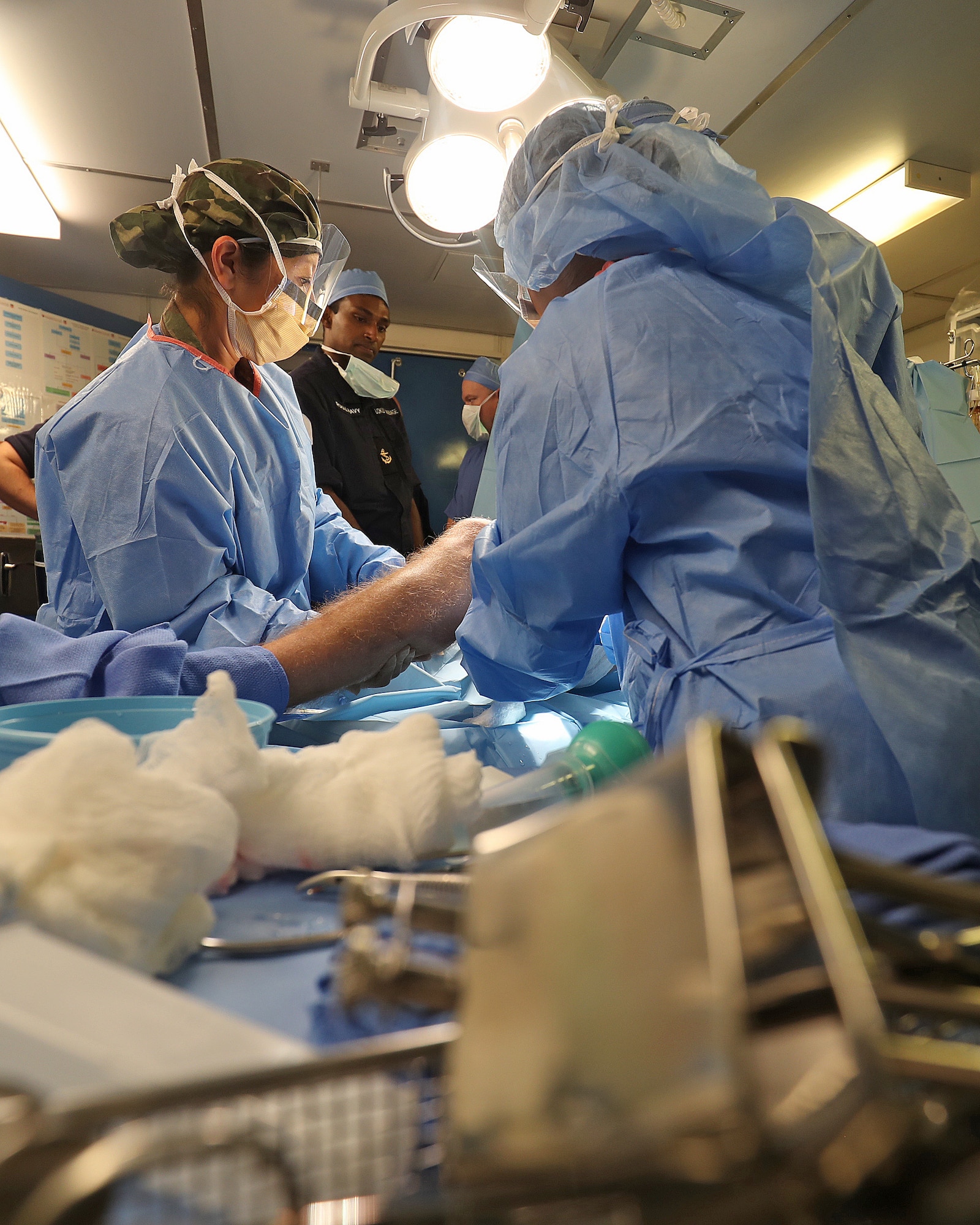 A combined Royal Navy and U.S. Air Force surgical team conduct a simulated operation to save a Royal Marine’s leg following an exercise gunshot wound, Jan. 26, 2017. The 379th Expeditionary Medical Operations Squadron mobile field surgical and critical care teams participated in exercise Azraq Serpent, where they worked with Royal Navy forces onboard the HMS Ocean. (Courtesy photo, Royal Navy)