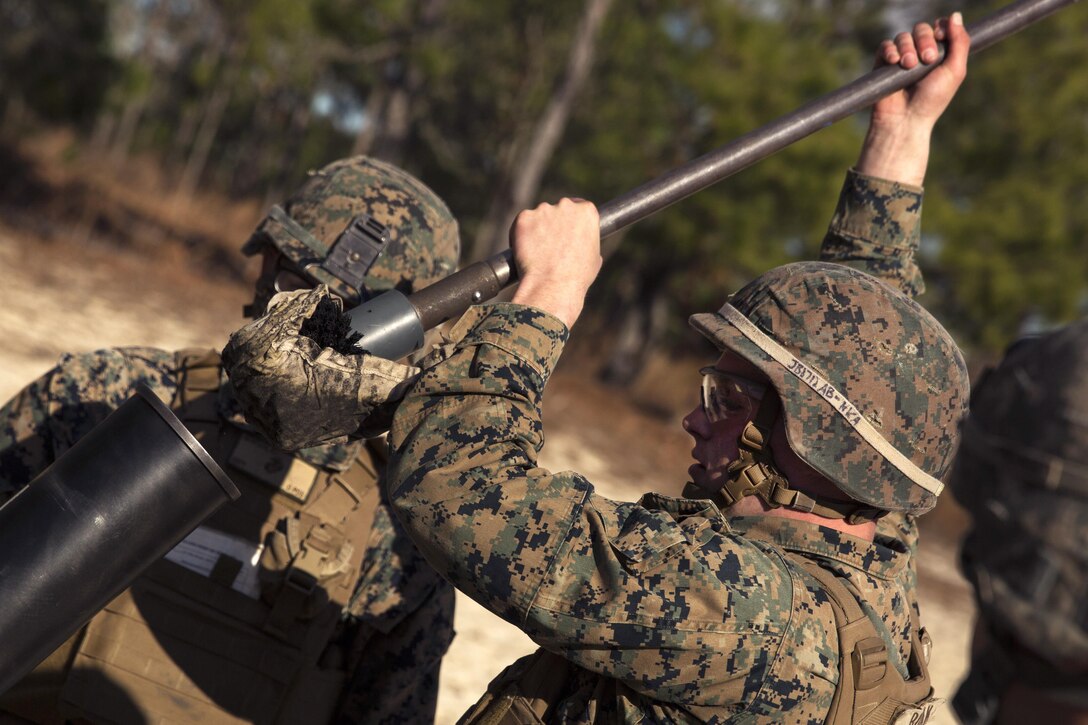 A Marine cleans the tube on an M121 A1 120 mm mortar system during live-fire training at Camp Lejeune, N.C., Jan. 24, 2017. Marine Corps photo by Sgt. Justin T. Updegraff