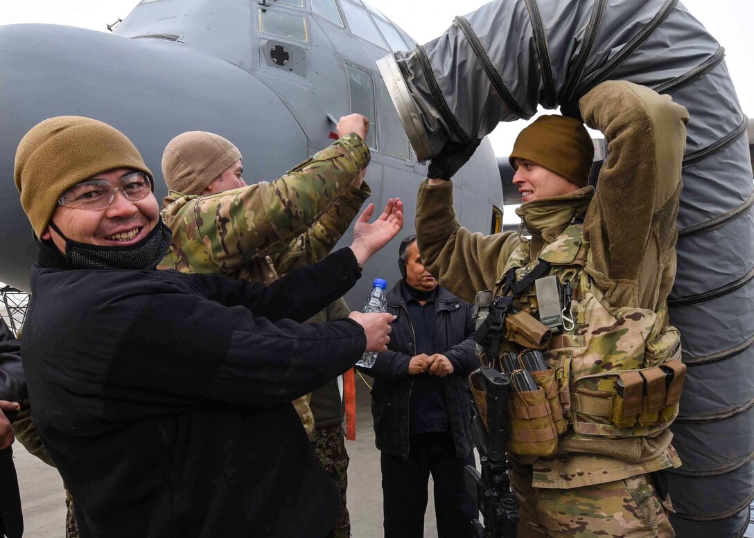 Tech. Sgt. Chad Conroy, 440th Air Expeditionary Advisory Squadron, C-130 maintenance advisor, a reservist assigned to Youngstown Air Reserve Station, Ohio, provides heat for Afghan Air Force maintainers before training at Kabul Air Wing, Afghanistan, Jan. 18, 2017. The AAF received four C-130H models at the beginning of 2014. On Jan. 11, 2017, a group of 44 AAF C-130H maintainers were the first in-country trained to graduate and receive their level three certification. (U.S. Air Force photo by Tech. Sgt. Veronica Pierce)