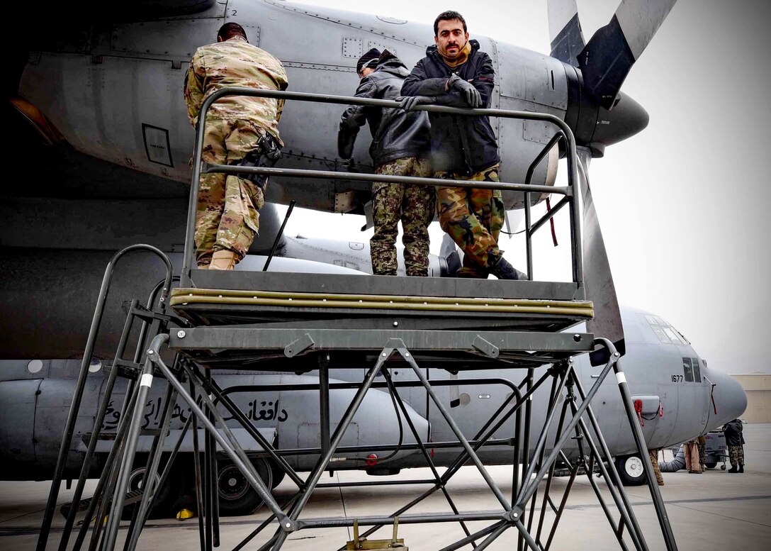 Tech. Sgt. Toron Bordain, 440th Air Expeditionary Advisory Squadron, C-130 maintenance advisor, works with his Afghan Air Force counterparts to remove an engine panel for training at Kabul Air Wing, Afghanistan, Jan. 18, 2017. Bordain, an Air Force Reservist out of Dobbins Air Reserve Base, Ga., is part Train, Advise, Assist Command-Air (TAAC-Air), working to develop a professional, capable and sustainable Afghan Air Force. (U.S. Air Force photo by Tech. Sgt. Veronica Pierce)