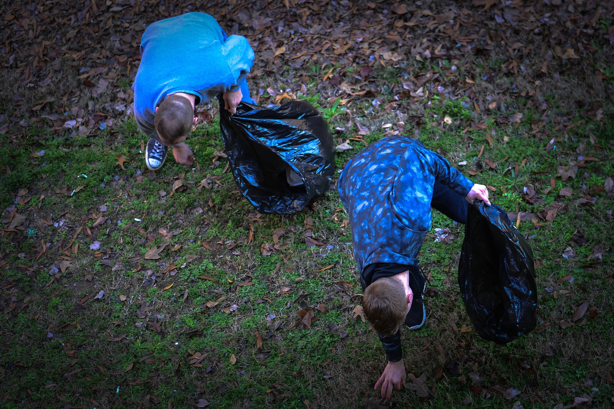 U.S. Air Force Airman 1st Class Devon Parrish, 20th Comptroller Squadron accounting technician, left, and Airman 1st Class Dylan Dykstra, 20th Logistics Readiness Squadron traffic management technician, right, pick up trash outside a dormitory during a dorm clean-up at Shaw Air Force Base, S.C., Jan. 28, 2017. Aside from cleaning the exterior of the dormitory, Airmen had the opportunity to provide feedback to their supervisors on items that may need maintenance. (U.S. Air Force photo by Airman 1st Class Christopher Maldonado)
