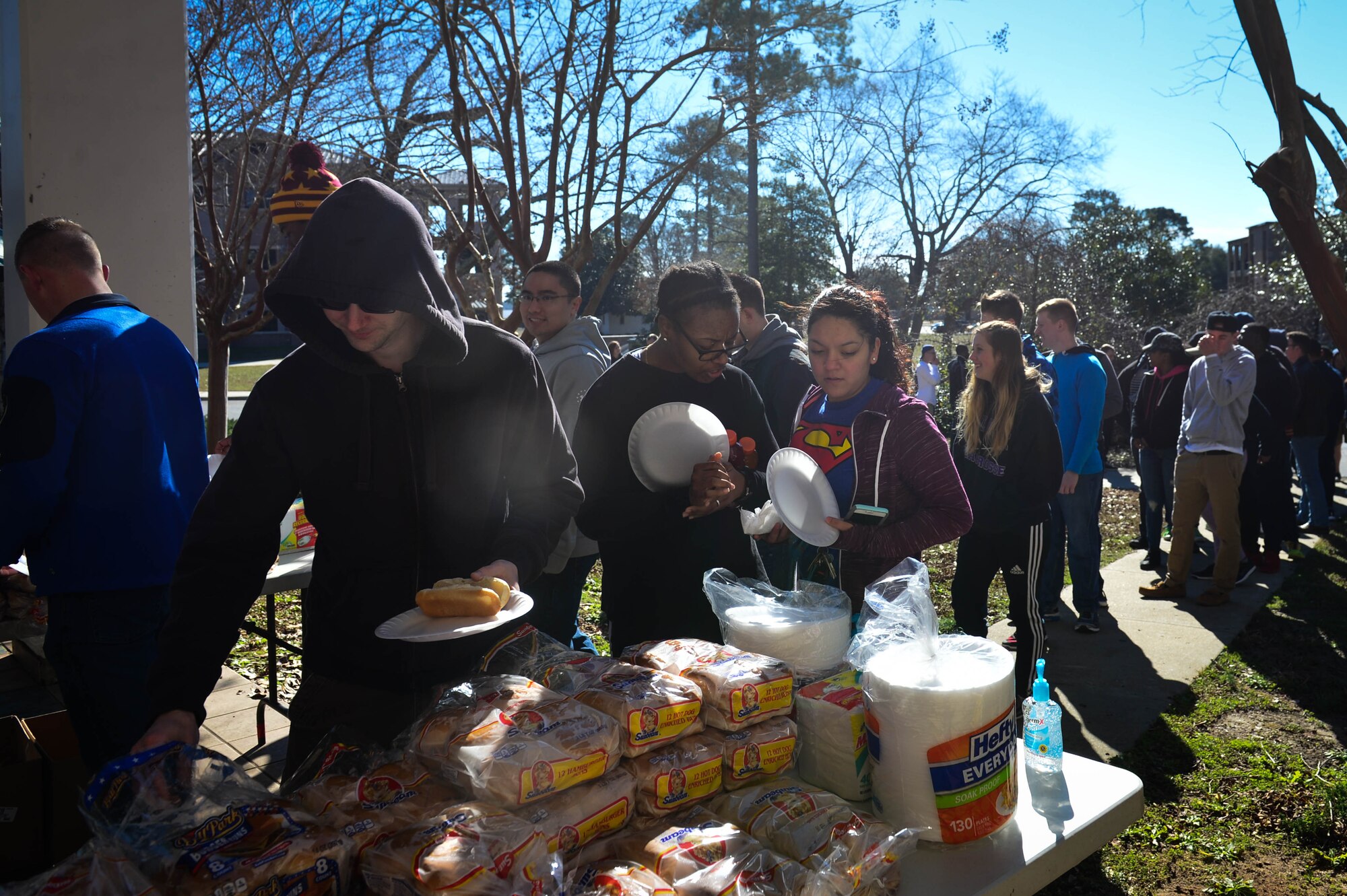 U.S. Airmen assigned to the 20th Fighter Wing wait in line for food after completing dorm clean-up at Shaw Air Force Base, S.C., Jan. 28, 2017. Supervisors and base leadership assisted with the cleaning and helped strengthen bonds with their wingmen. (U.S. Air Force photo by Airman 1st Class Christopher Maldonado)