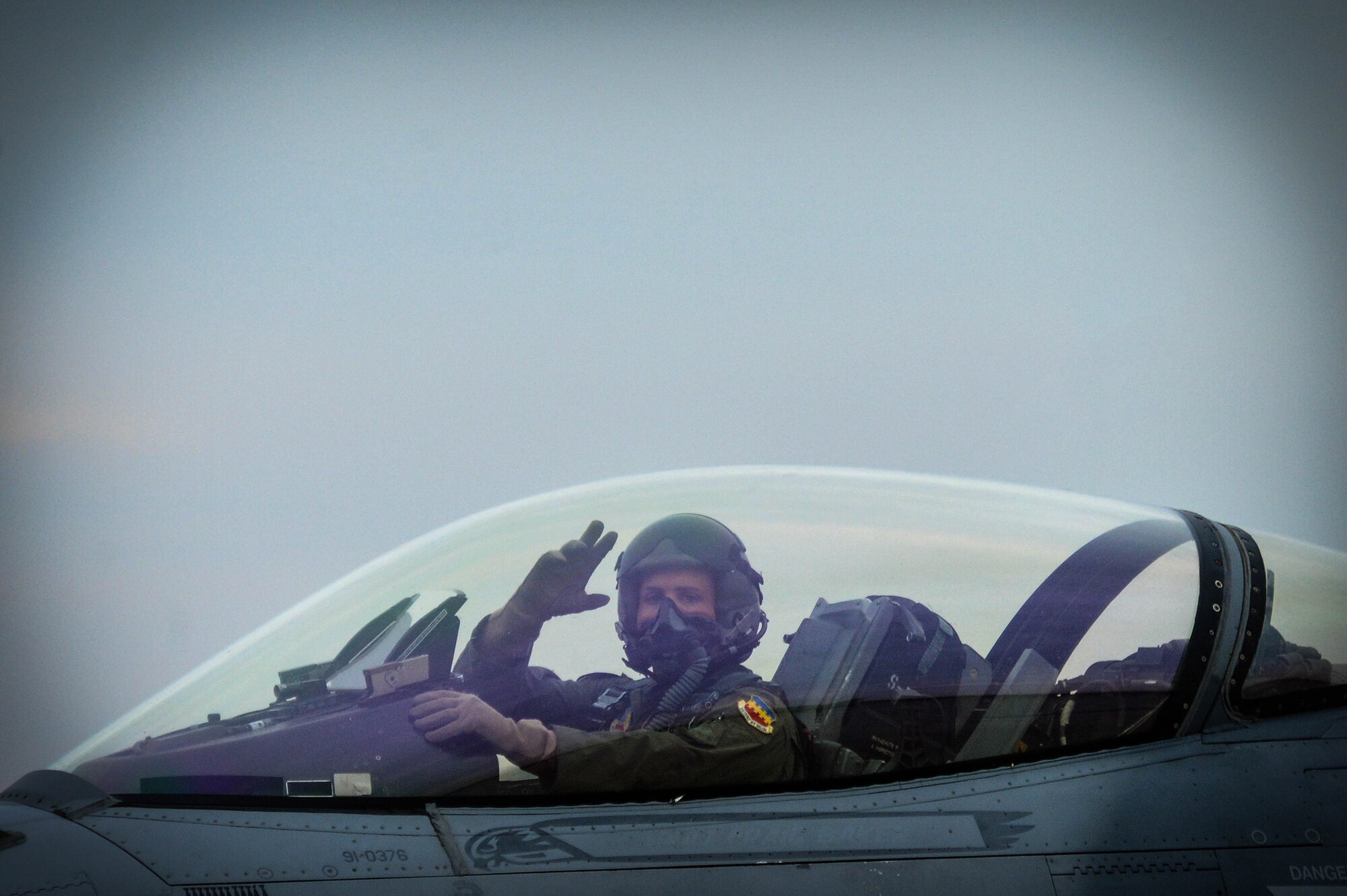 U.S. Air Force Capt. John Waters, F-16 Viper Demonstration Team pilot, waves before takeoff for the 20th Fighter Wing certification flight over Shaw Air Force Base, S.C., Jan. 9, 2017. The mission of the team is to inspire the future generation of pilots and maintainers through their combat demonstration of the aircraft. The F-16CM Fighting Falcon has a General Electric F-129 engine capable of producing over 27,000 pounds of thrust, which translates to more horse power than the entire starting lineup of the Indianapolis 500. (U.S. Air Force photo by Senior Airman Michael Cossaboom)