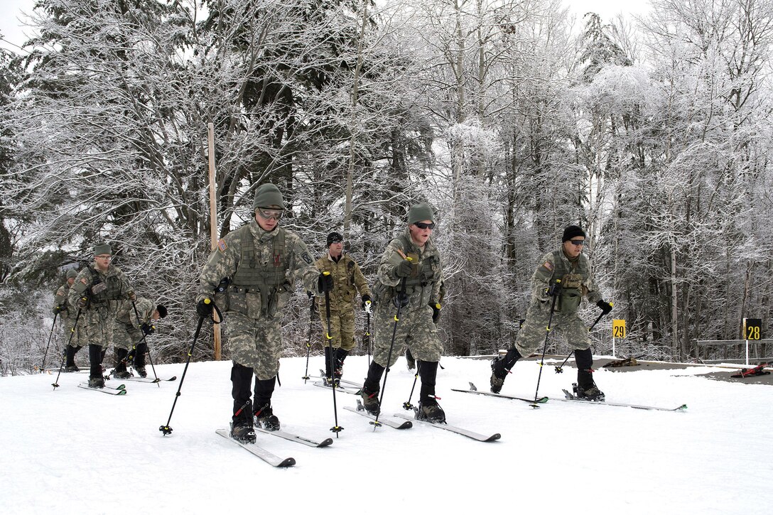 Army National Guardsmen maneuver on skis before participating in marksmanship training at the Camp Ethan Allen Training Site, Jericho, Vt., Jan. 25, 2017. Air National Guard photo by Tech. Sgt. Sarah Mattison 
