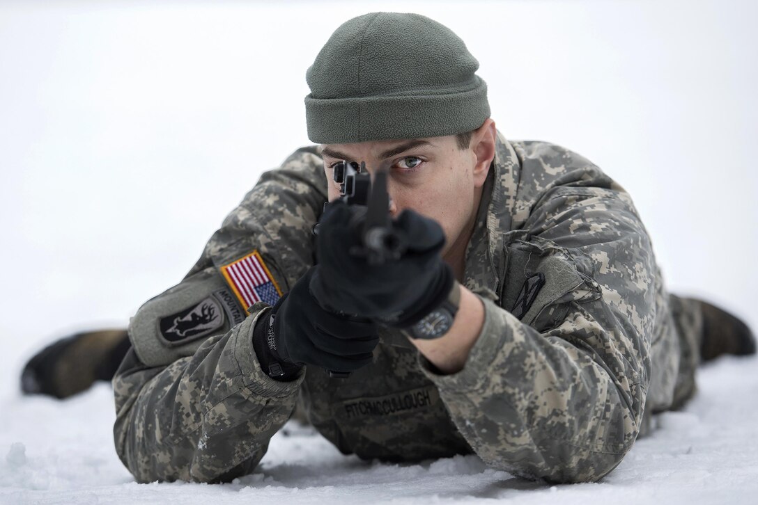 Army National Guard Staff Sgt. Robin Fitch-McCullough demonstrates proper rifle aiming technique during marksmanship training at the Camp Ethan Allen Training Site, Jericho, Vt., Jan. 25, 2017. Fitch-McCullough is an infantryman assigned to the Vermont Army National Guard’s Company A, 3rd Battalion, 172nd Infantry Regiment, 86th Infantry Brigade Combat Team (Mountain). Air National Guard photo by Tech. Sgt. Sarah Mattison
