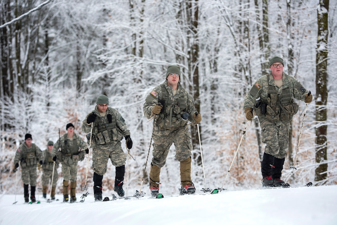 Army National Guardsmen maneuver on skis before participating in marksmanship training at the Camp Ethan Allen Training Site, Jericho, Vt., Jan. 25, 2017. Air National Guard photo by Tech. Sgt. Sarah Mattison