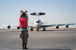 380th Expeditionary Aircraft Maintenance Squadron crew chief Airman 1st Class Mitchell signals an E-3 Sentry before completing a sortie in support of Combined Joint Task Force-Operation Inherent Resolve at an undisclosed location in Southwest Asia, Feb. 2, 2017. “Keeping the jets in the air for 14-16 hours a day is a really big deal,” Mitchell said.  “Seeing them comeback after completing a safe flight is what keeps me motivated to do this job.” (U.S. Air Force photo by Senior Airman Tyler Woodward)