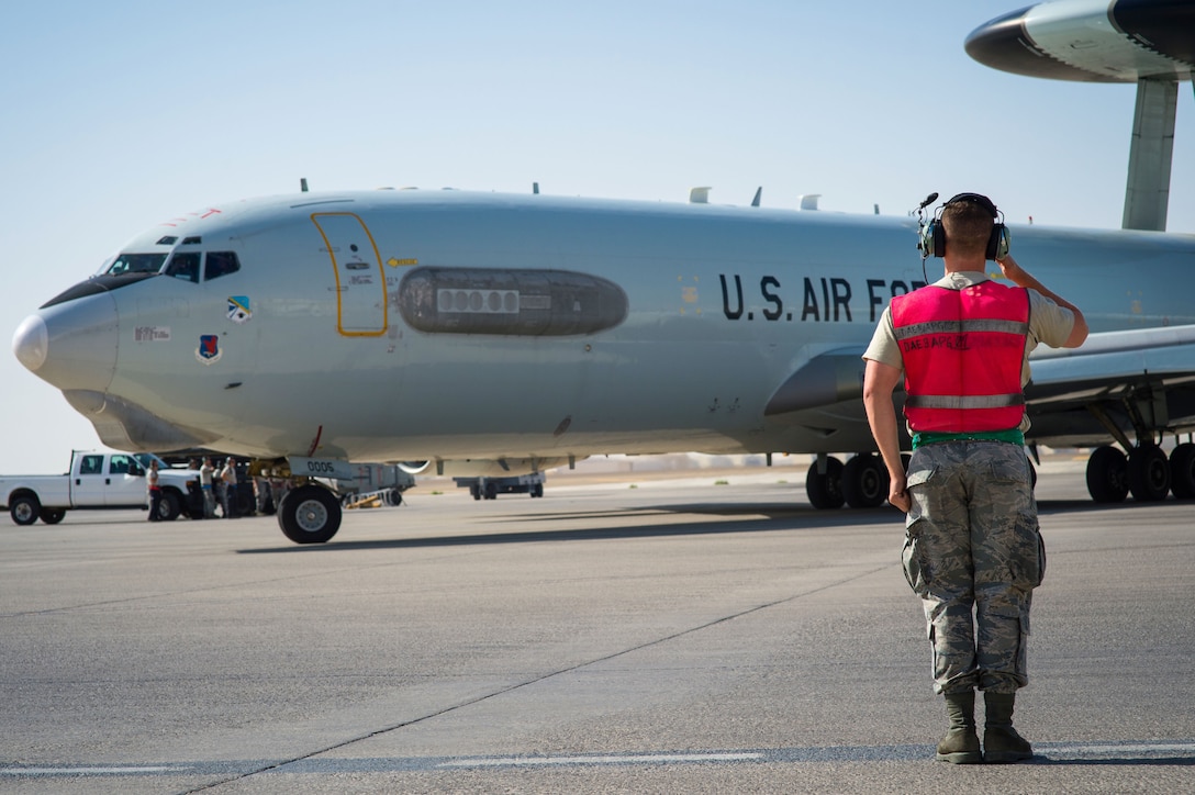 380th Expeditionary Aircraft Maintenance Squadron crew chief Airman 1st Class Mitchell signals an E-3 Sentry before completing a sortie in support of Combined Joint Task Force-Operation Inherent Resolve at an undisclosed location in Southwest Asia, Feb. 2, 2017. “Keeping the jets in the air for 14-16 hours a day is a really big deal,” Mitchell said.  “Seeing them comeback after completing a safe flight is what keeps me motivated to do this job.” (U.S. Air Force photo by Senior Airman Tyler Woodward)