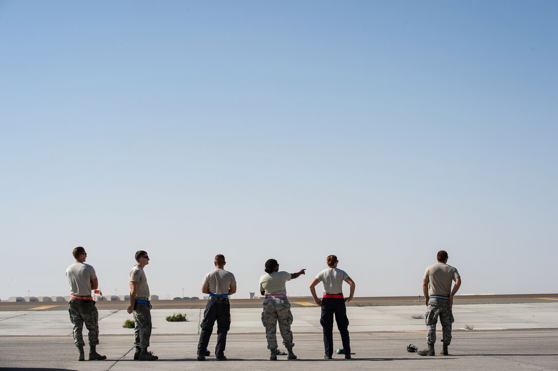 380th Expeditionary Aircraft Maintenance Squadron Airmen watch an E-3 Sentry before it departs and completes a sortie in support of Combined Joint Task Force-Operation Inherent Resolve at an undisclosed location in Southwest Asia, Feb. 2, 2017. After every preflight inspection, the E-3 Sentry maintainers complete as many push-ups as possible while the aircraft takes off. (U.S. Air Force photo by Senior Airman Tyler Woodward)