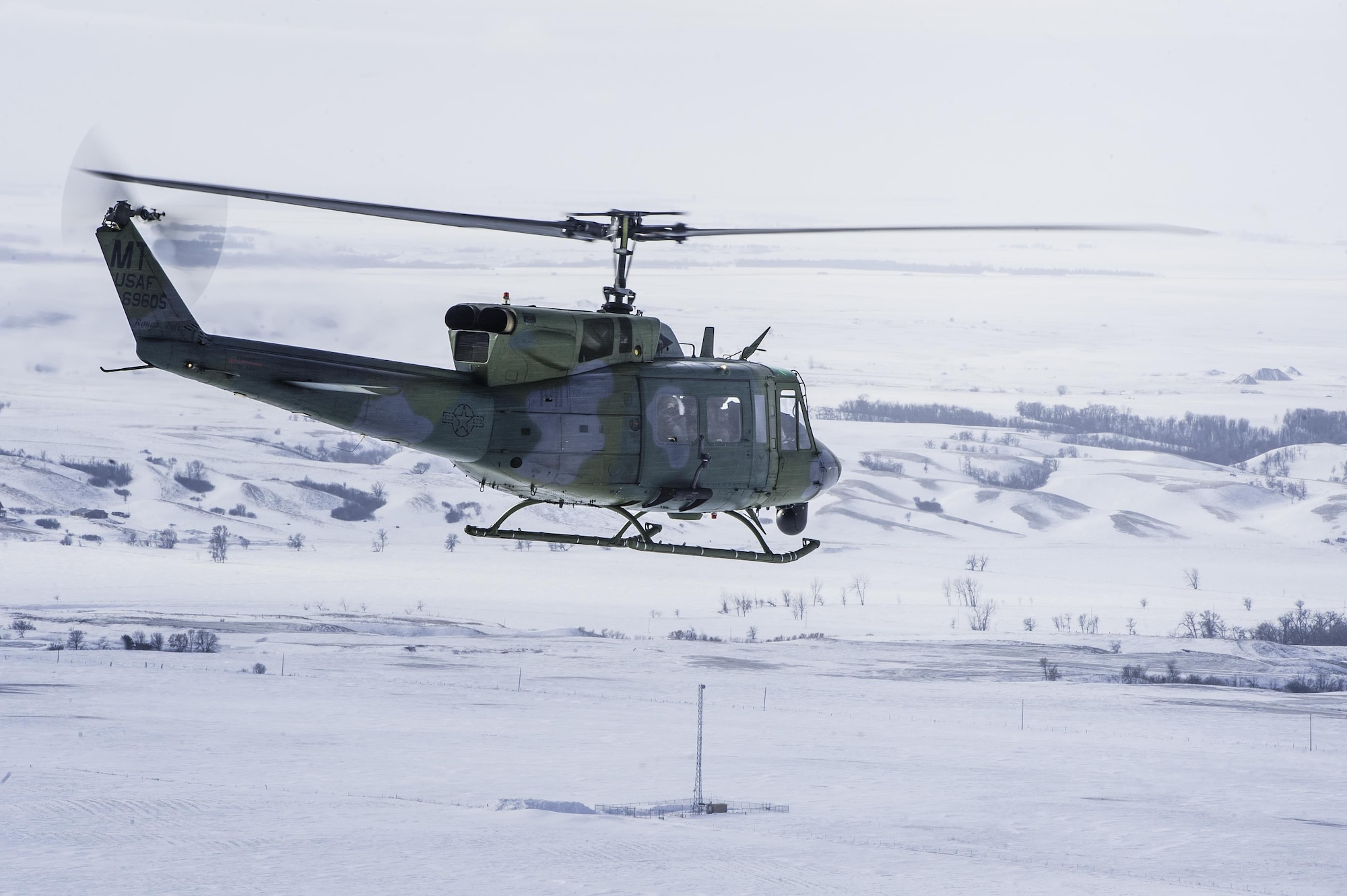 A UH-1N Iroquois from the 54th Helicopter Squadron flies over Minot Air Force Base’s missile complex, N.D., Jan. 25, 2017. The purpose of the flight was to perform training maneuvers and complete a security sweep of 91st Missile Wing launch facilities.  The 54th HS’s fleet is critical in providing support to 91st MW Airmen and assets in the missile complex. (U.S. Air Force photo/Airman 1st Class J.T. Armstrong)