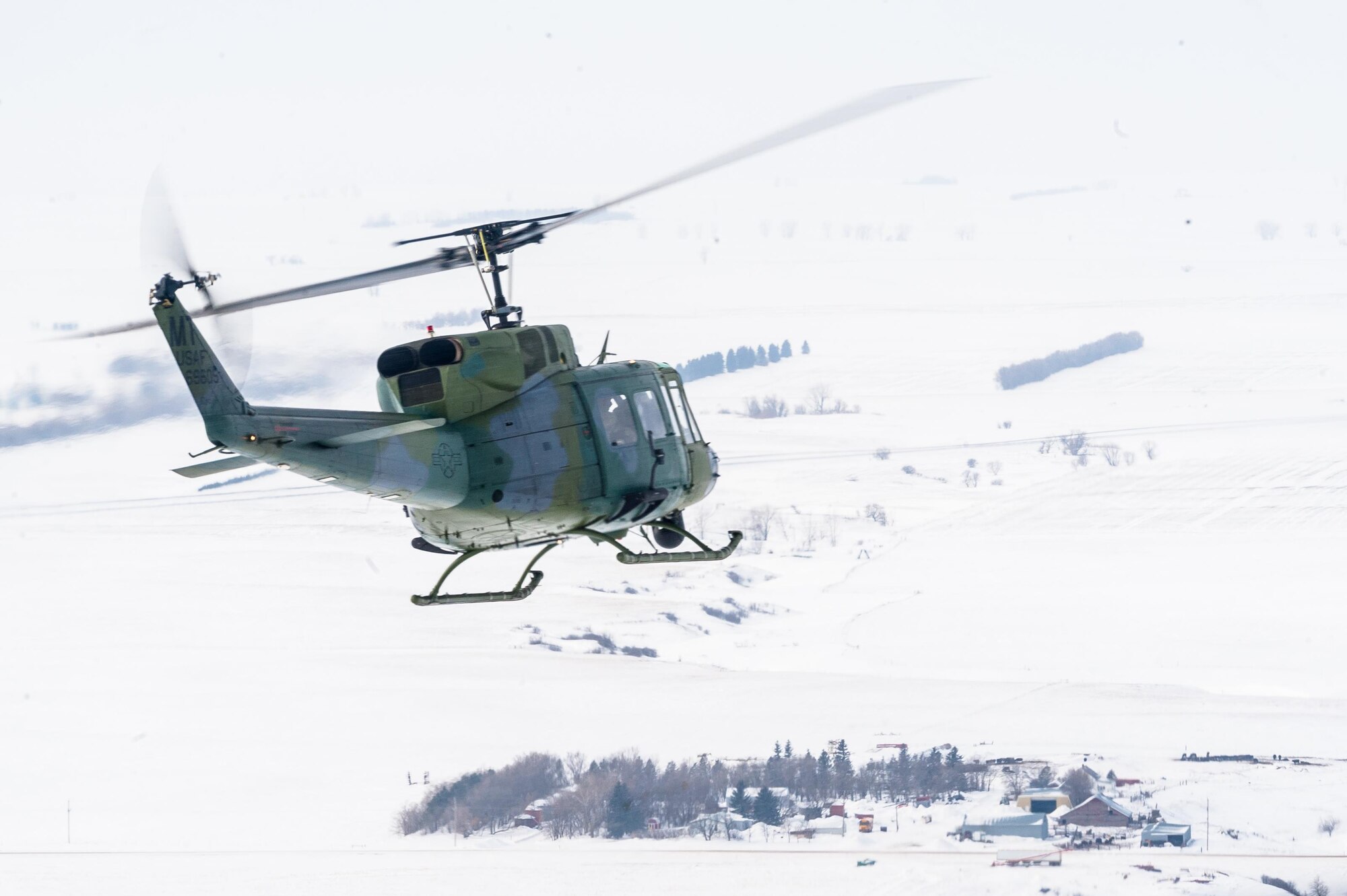 A UH-1N Iroquois from the 54th Helicopter Squadron flies over Minot Air Force Base’s missile complex, N.D., Jan. 25, 2017. The purpose of the flight was to perform training maneuvers and complete a security sweep of 91st Missile Wing launch facilities.  The 54th HS’s fleet is critical in providing support to 91st MW Airmen and assets in the missile complex. (U.S. Air Force photo/Airman 1st Class J.T. Armstrong)