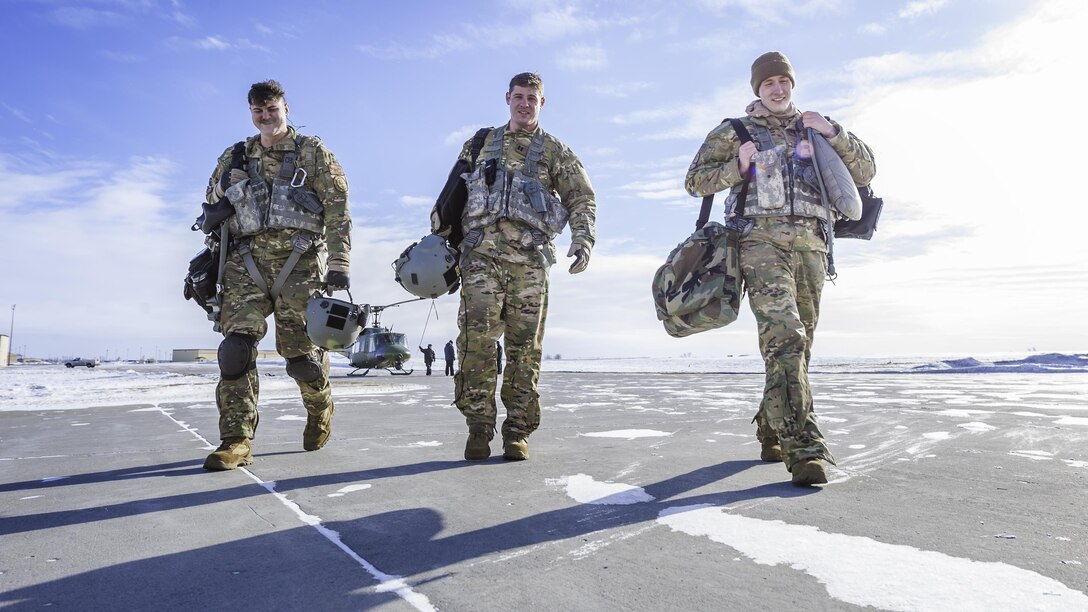 A UH-1N Iroquois flight crew from the 54th Helicopter Squadron walks through the snow at Minot Air Force Base, N.D., Jan. 25, 2017.  The 54th HS’s fleet is critical in providing support to 91st MW Airmen and assets in the missile complex. (U.S. Air Force photo/Airman 1st Class J.T. Armstrong)