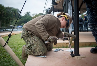 PUERTO BARRIOS, Guatemala- Utilitiesman 2nd Class Kristina Sosa, a native of Aurora, Ill., attached to Construction Battalion Maintenance (CBMU) 202, secures a tent in Puerto Barrios, Guatemala, in support of Continuing Promise 2017 (CP-17). The team assembled tents following the mission’s arrival in the country. CP-17 is a U.S. Southern Command-sponsored and U.S. Naval Forces Southern Command/U.S. 4th Fleet-conducted deployment to conduct civil-military operations including humanitarian assistance, training engagements, and medical, dental, and veterinary support in an effort to show U.S. support and commitment to Central and South America. (U.S. Navy Photo by Mass Communication Specialist 2nd Class Shamira Purifoy)