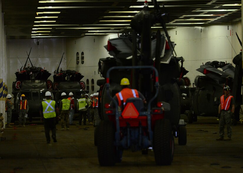 Department of Defense-contracted longshoremen on-load helicopters form the 10th Combat Aviation Brigade (CAB). More than 900 pieces of equipment were loaded onto the transport ship ARC Endurance, January 25, 2017, at Joint Base Charleston, S.C. – Weapons Station. Members from the 10th Combat Aviation Brigade and the 841st Transportation Battalion staged, processed and configured the equipment in support of Operation Atlantic Resolve 2.0.