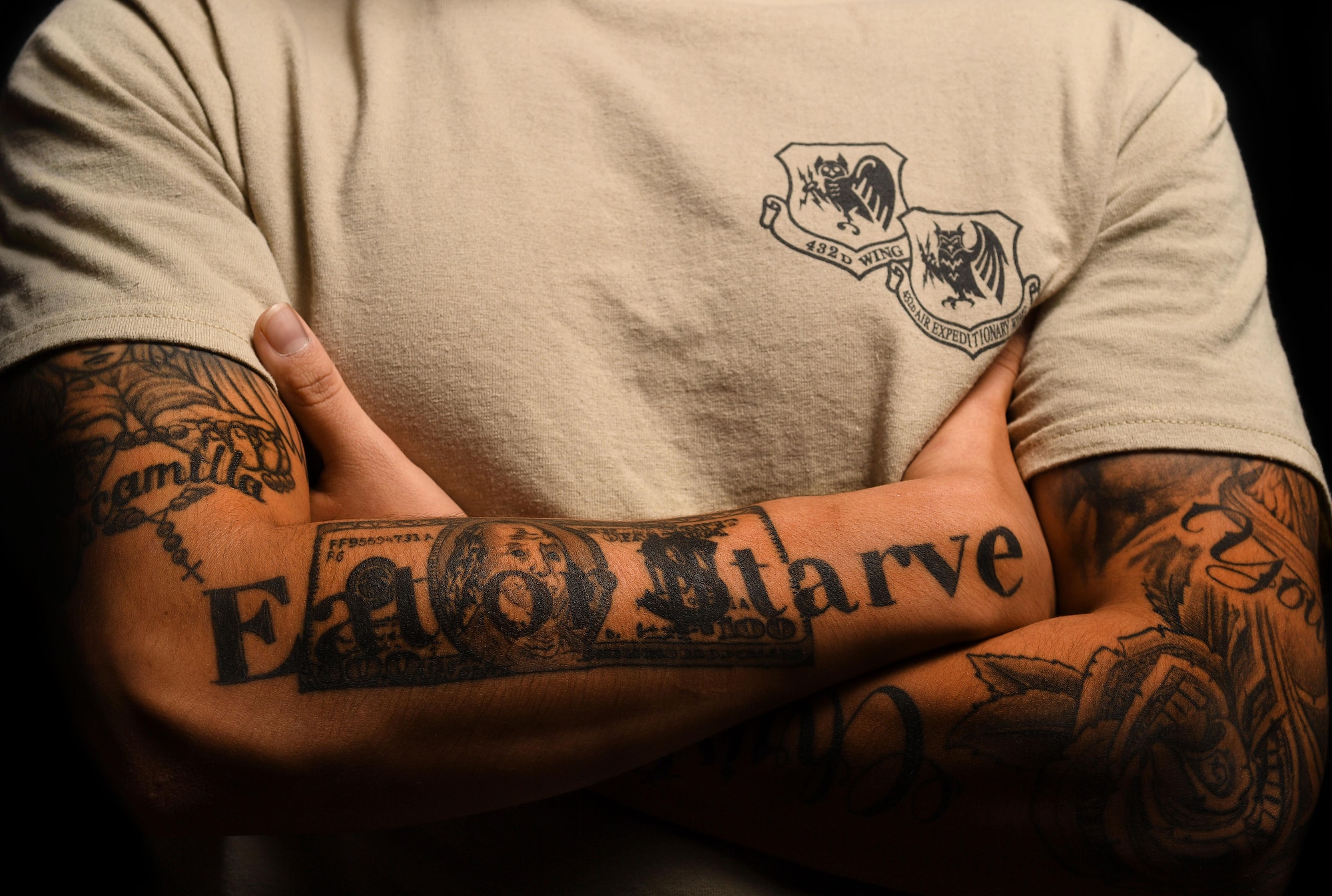 Senior Airman DelAngel, 432nd Wing administration journeyman, displays his tattoos Jan. 18, 2017, at Creech Air Force Base, Nev. As of Feb. 1, 2017, a new tattoo policy has taken effect as a result of the Air Force’s efforts in broadening the pool of applicants and retaining Airmen. DelAngel believes his ethos, ‘Eat or starve,’ represents his hard-working mentality and culture. (U.S. Air Force photo by Airman 1st Class James Thompson)