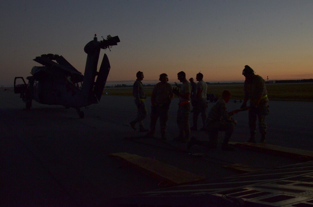To ensure the flying safety of Air Force choppers used to save lives in combat, maintenance crews from the 920th Rescue Wing swap out an HH-60G Pave Hawk helicopter for reconditioning January 25, 2017. A team of 10 maintainers is necessary to skillfully muscle the metal warrior into the cargo bay however, more often join the unique event for hands-on training and to secure the warrior on a smooth journey over an ocean and a continent to trade places with the combat-weary aircraft. (U.S. Air Force photo/Maj. Cathleen Snow)
