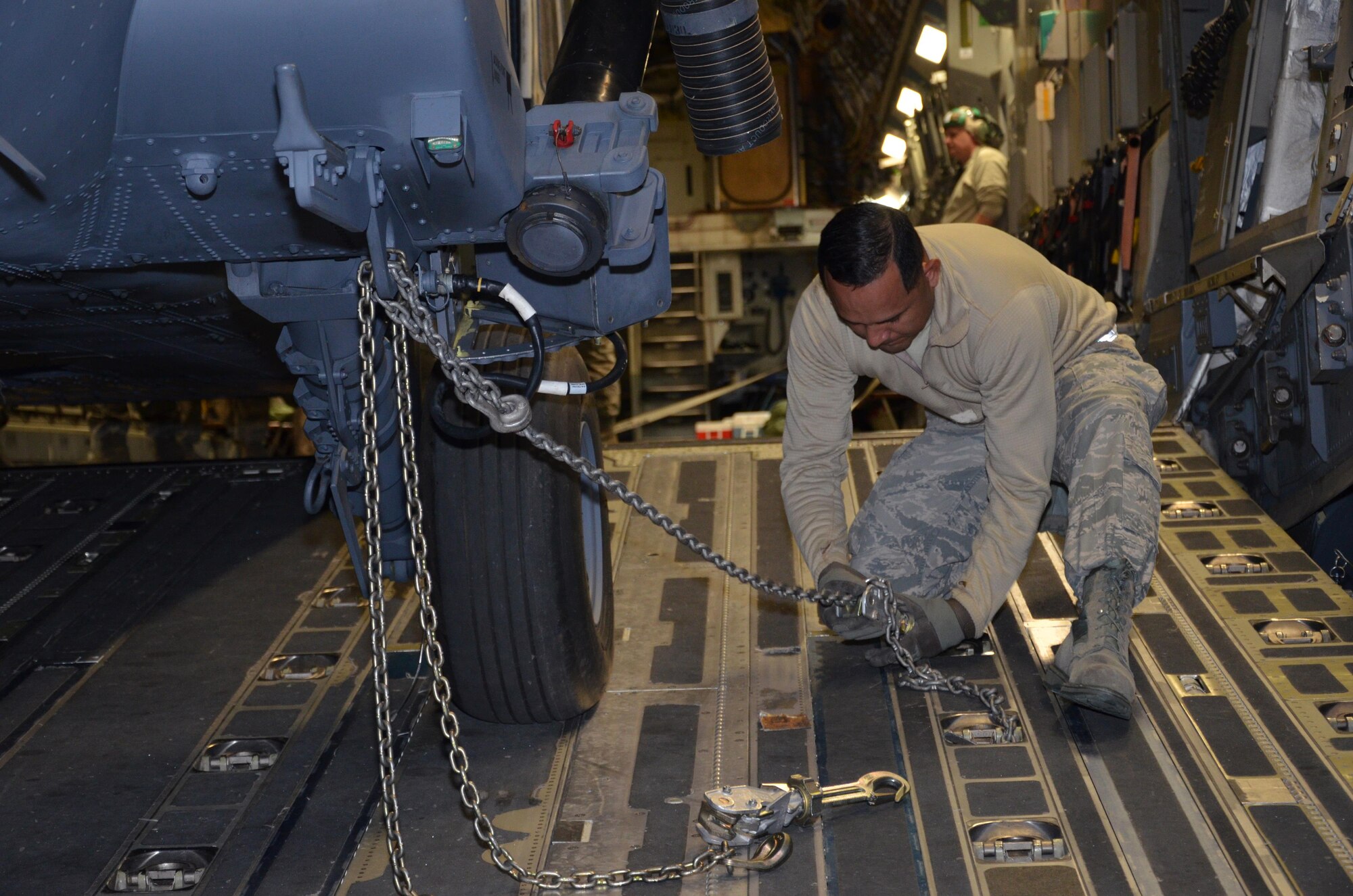 To ensure the flying safety of Air Force choppers used to save lives in combat, maintenance crews from the 920th Rescue Wing swap out an HH-60G Pave Hawk helicopter for reconditioning January 25, 2017. A team of 10 maintainers is necessary to skillfully muscle the metal warrior into the cargo bay however, more often join the unique event for hands-on training and to secure the warrior on a smooth journey over an ocean and a continent to trade places with the combat-weary aircraft. (U.S. Air Force photo/Maj. Cathleen Snow)
