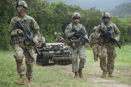 U.S. Army official file photo:  A Punisher unmanned ground vehicle follows Soldiers during the PACMAN-I experiment in Hawaii.