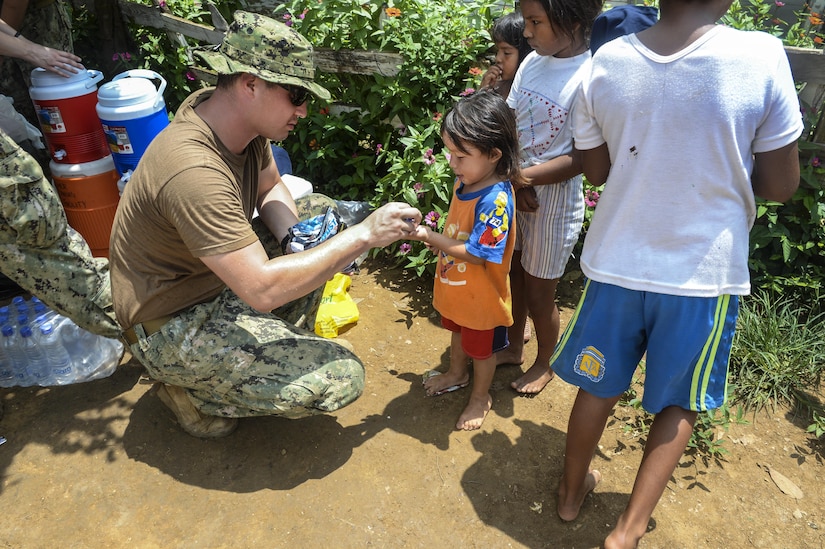 Hospital Corpsman Third Class Anthony Salazar, assigned to Naval Health Clinic Charleston, hands out treats to local children.  As a member of the Construction Engagement Team, HM3 Salazar was in Colombia building a latrine for the Cabildo Indigena Zenu community during Southern Partnership Station 2016 (SPS-16).  SPS-16 is an annual series of U.S. Navy deployments, fostering a lasting relationship with the people of Central and South America through exercises, operations and community relation projects. 