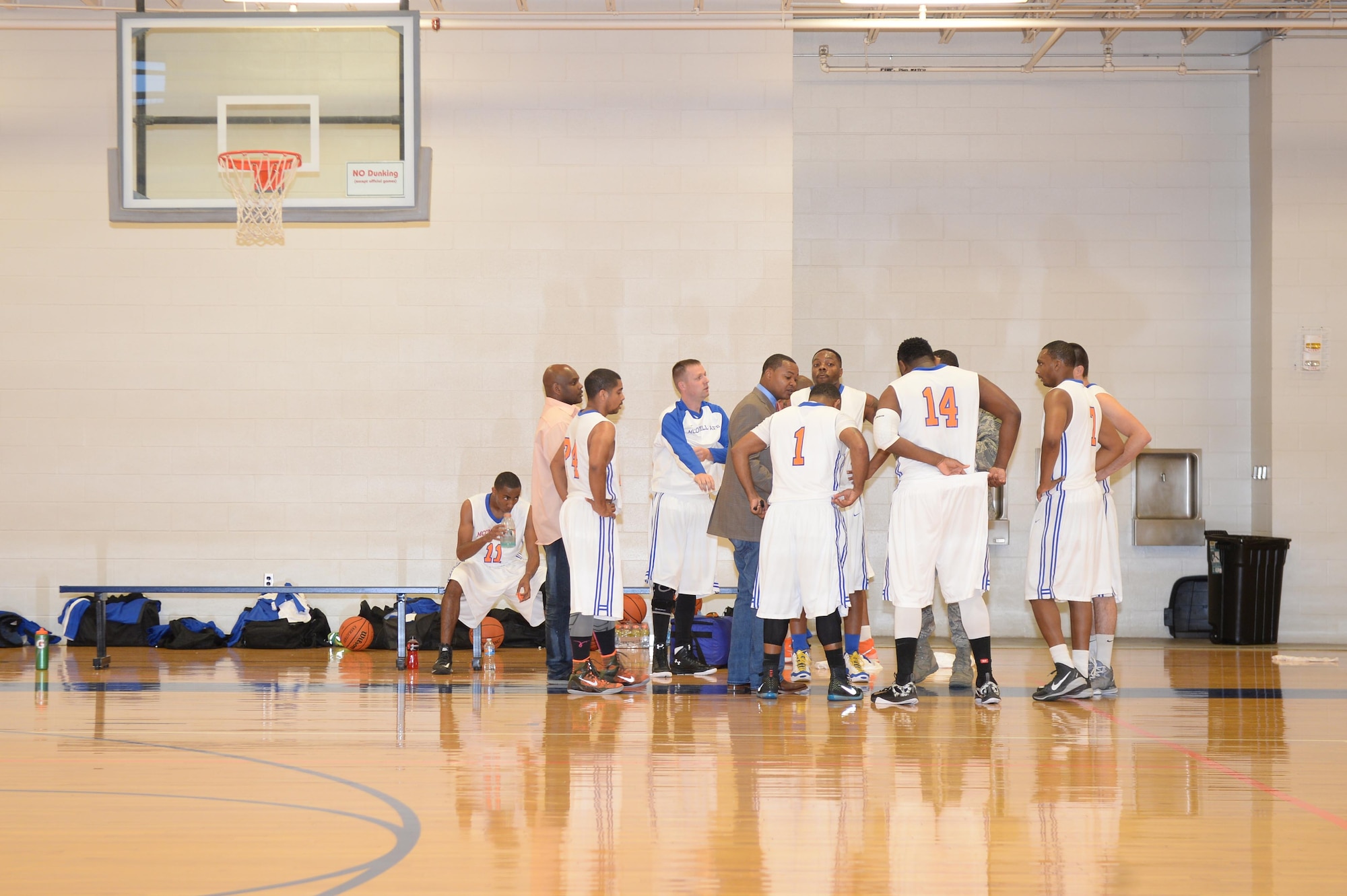 The McConnell Tornadoes huddle during half-time of a game with the Tinker Hawks, Oct. 17, 2015, at McConnell Air Force Base, Kan. The team focuses on communication to be effective on the court and while performing the mission as Airmen. (U.S. Air Force photo/Senior Airman Colby L. Hardin)