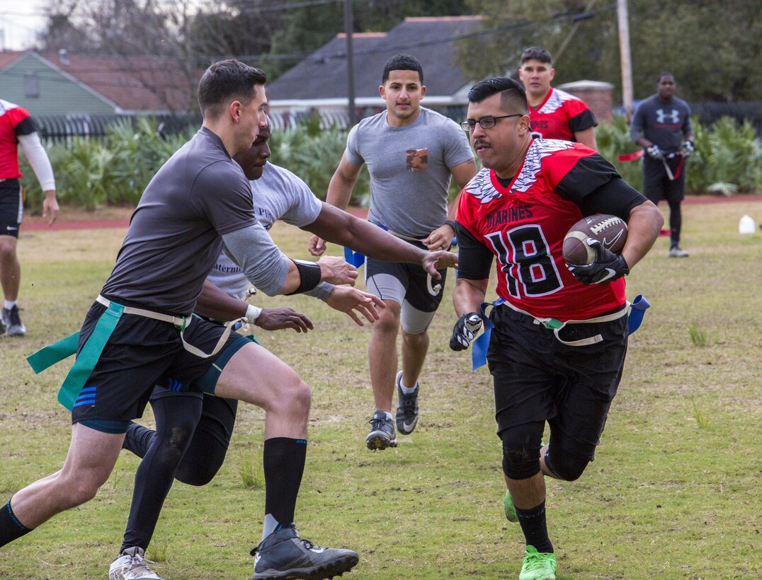 Sgt. Matthew J. Duran (right), Marine Corps Individual Reserve Support Activity adjutant noncommissioned officer in charge, Marine Forces Reserve, runs to make a touchdown for team Goons during the Marine Corps Support Facility New Orleans Super Bowl tournament, Jan. 27, 2017. The tournament was held to build camaraderie, unit cohesion and esprit de corps between all departments within MARFORRES Headquarters. (U.S. Marine Corps photo by Lance Cpl. Dallas Johnson/Released)