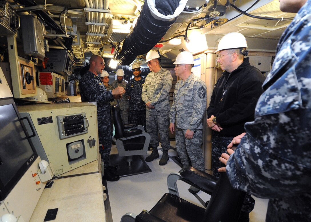 U.S. Air Force Gen. John E. Hyten (center), commander of U.S. Strategic Command (USSTRATCOM) receives a brief on how the U.S. Submarine Force supports USSTRATCOM mission requirements at Naval Air Station Norfolk, Va. Hyten is visiting submarine forces, his first as commander of USSTRATCOM, to see the operations of one leg of the nuclear triad. One of nine DoD unified combatant commands, USSTRATCOM has global strategic missions assigned through the Unified Command Plan that include strategic deterrence; space operations; cyberspace operations; joint electronic warfare; global strike; missile defense; intelligence, surveillance and reconnaissance; and analysis and targeting.